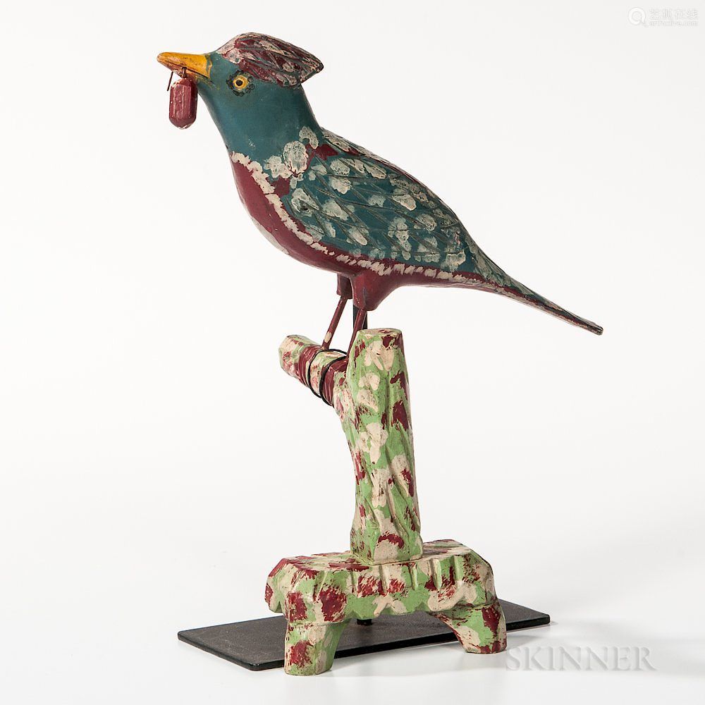 small carved and painted bird on perch