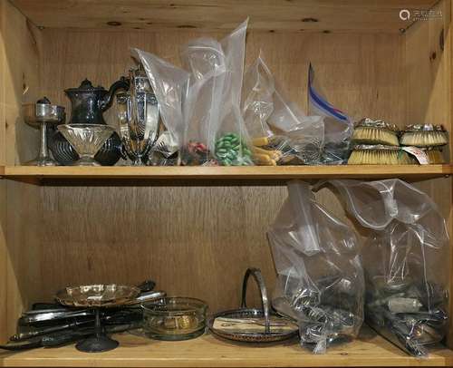 Two shelves of decorative art including silver plate