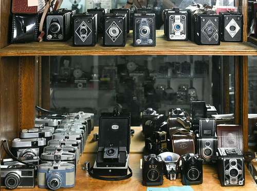 Two shelves of Bilora cameras and cases