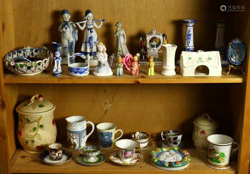 Two shelves of decorative art including Belleek, a