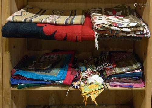 Two shelves of international textiles including Haitian