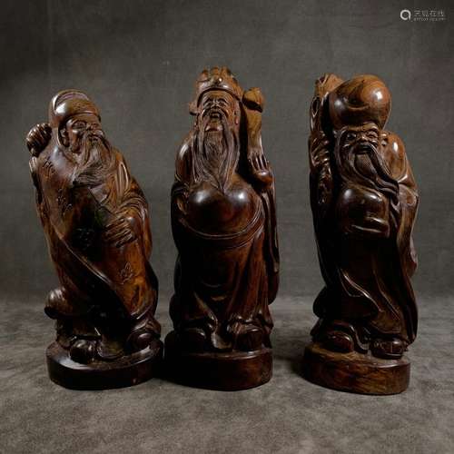 A Set of Three Chinese Carved Huanghuali Figures