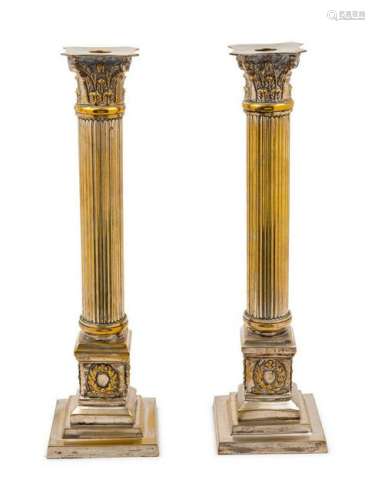 A Pair of Silvered Metal Candlesticks in the f