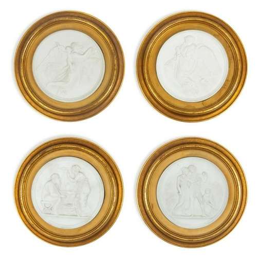 A Group of Four Bisque Plaques  each set in a