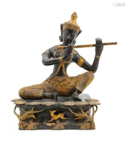 A Thai Gilt and Patinated Bronze Flute Player