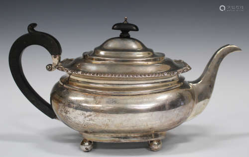 A George V silver cushion shaped teapot with gadrooned rim, raised on ball feet, London 1913 by