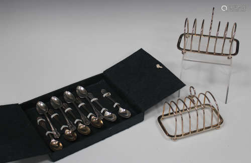A pair of Elizabeth II silver six-division toast racks, raised on ball feet, Sheffield 1966 and 1967