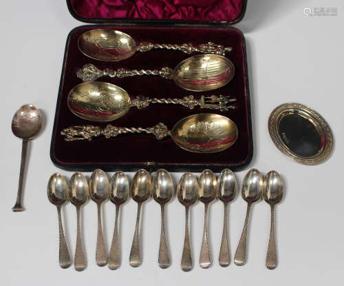 A set of four late Victorian silver gilt berry spoons with cast figural handles, London 1883 by