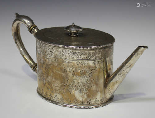 A Victorian silver teapot of oval form with beaded rims, engraved with foliate scrolls framing a
