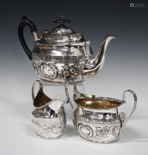 A late Victorian silver teapot with integral plated strainer and two-handled sugar bowl, each of