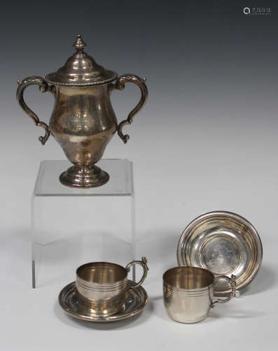 A George V silver two-handled trophy cup and cover of baluster form with scroll handles,