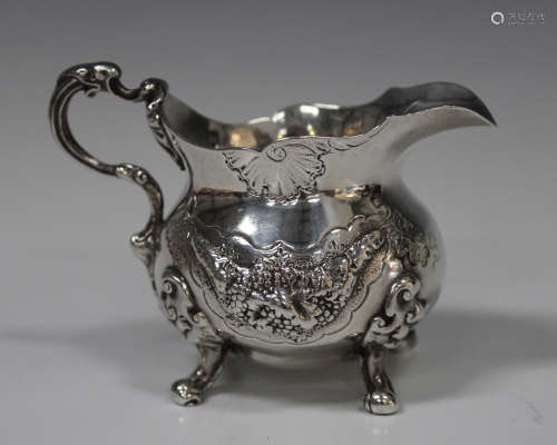 An early Victorian silver cream jug of squat baluster form, decorated in relief with panels of