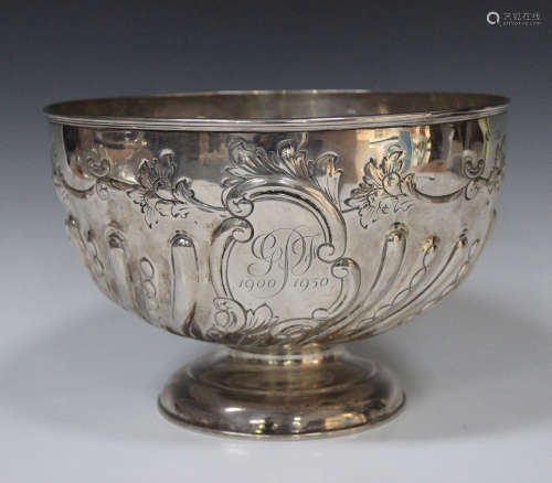 A late Victorian silver circular punch bowl with half spiral reeded fruit and leaf decoration, on