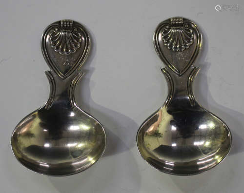 A pair of George IV silver caddy spoons, each with oval bowl, the heart shaped handle with shell