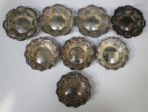 A set of four late Victorian silver circular bonbon dishes, embossed with foliate scrolls, Sheffield