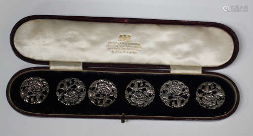 A set of six early 20th century white metal circular buttons, each cast and pierced with roses and