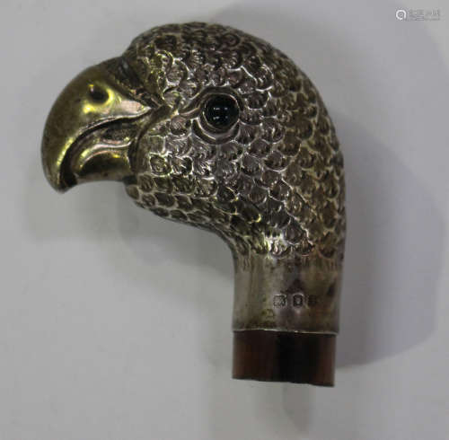 A George V silver novelty parasol handle in the form of a parrot's head with green glass eyes,