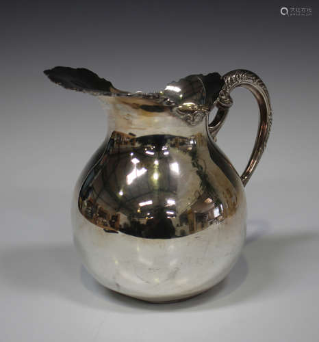 A Peruana silver milk jug of ovoid form, the flared spout cast with a scroll rim, flanked by a