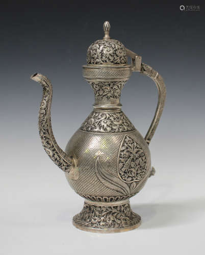 An Indian style plated ewer, the baluster body and domed hinged cover decorated with relief panels