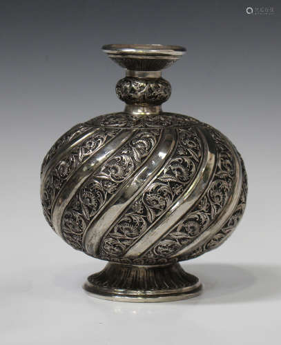 An Indian style plated hookah base, the globular body and neck decorated with spiral foliate