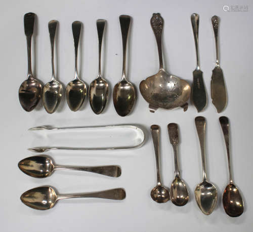 A group of Georgian and later silver cutlery, including a pair of Fiddle pattern sugar tongs, a