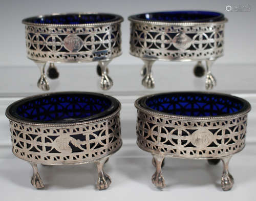 A near set of four George III silver salts of oval form, each with pierced sides and beaded rim,