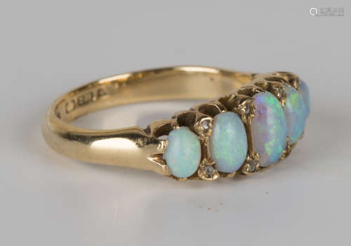 An 18ct gold, opal and diamond ring, mounted with a row of five graduated oval opals and four