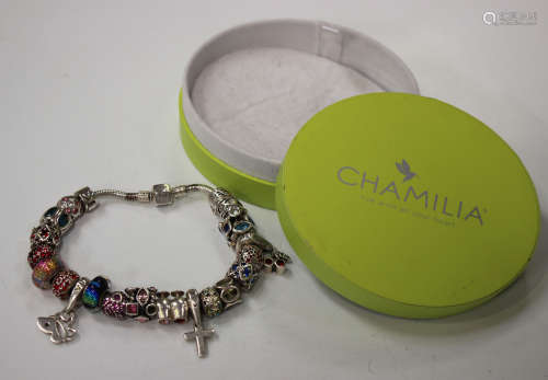 A Chamilia silver charm bracelet, the Brazil link chain fitted with a variety of sliding charms,