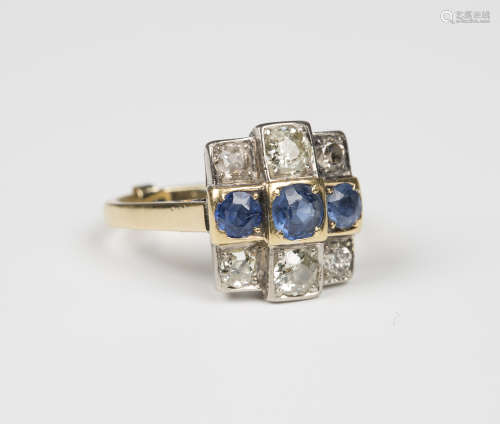 A gold, diamond and sapphire ring, mounted with a row of three cushion shaped sapphires between