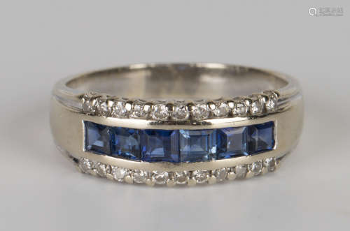 A white gold, sapphire and diamond half-hoop ring, mounted with a row of six square cut sapphires