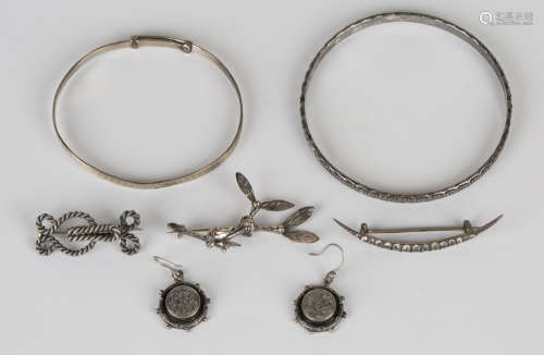 A pair of Victorian silver earrings, each of circular form with engraved decoration within a