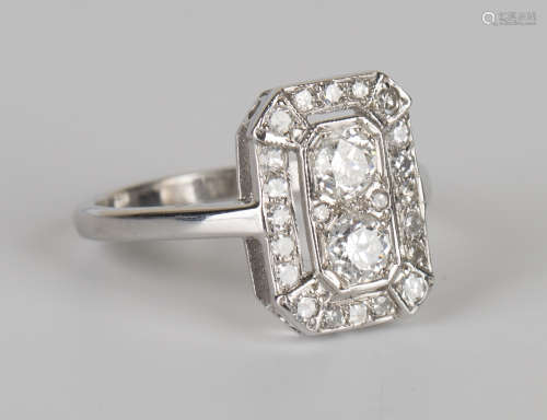 A white gold and diamond rectangular panel shaped ring, mounted with two principal circular cut