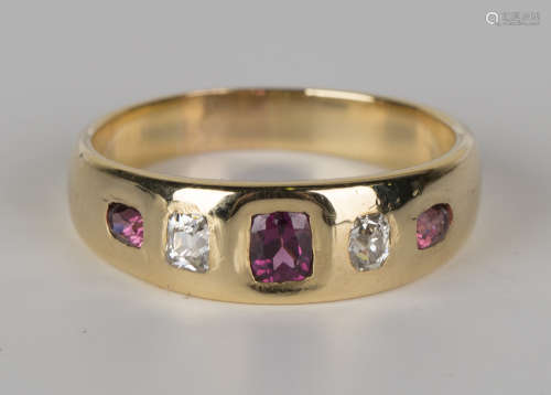 A gold, almandine garnet and diamond ring, mounted with three almandine garnets alternating with two