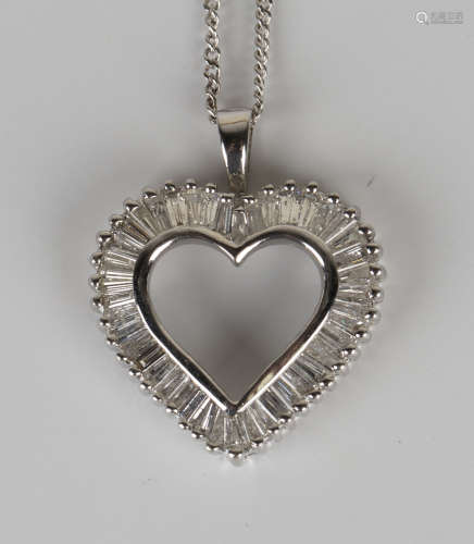 A white gold and diamond open heart shaped pendant, mounted with tapered baguette cut diamonds