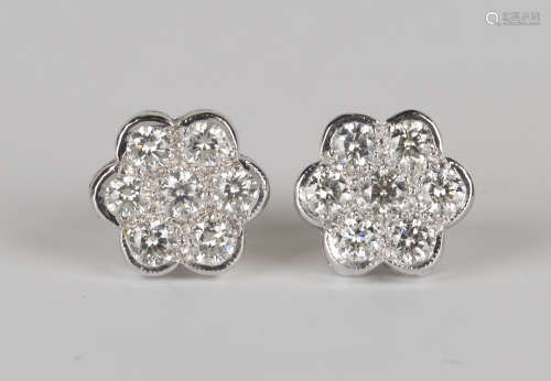 A pair of white gold and diamond cluster earstuds, each mounted with seven circular cut diamonds