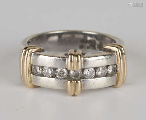 A 9ct yellow and white gold ring, mounted with a row of seven circular cut diamonds, ring size