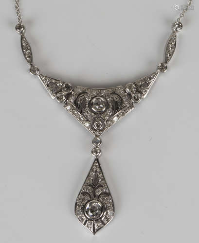 An 18ct white gold and diamond necklace in a pierced crescent shaped design with a pierced drop