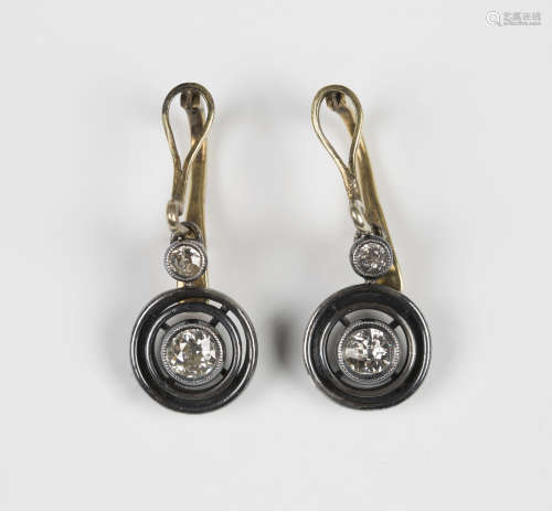 A pair of diamond two stone pendant earrings, each collet set with the principal cushion shaped