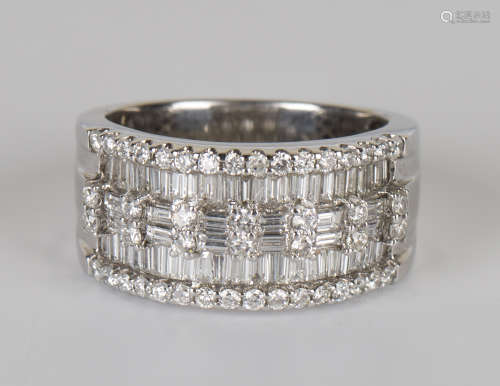An 18ct white gold and diamond ring, mounted with baguette and circular cut diamonds in a five row