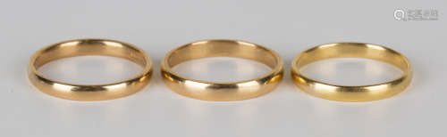 Three 22ct gold plain wedding rings, ring sizes approx V1/2 and W.Buyer’s Premium 29.4% (including