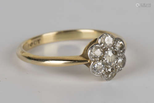 A gold and diamond seven stone cluster ring, mounted with cushion shaped diamonds, detailed '