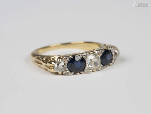 A gold, sapphire and diamond five stone ring, mounted with three cushion shaped diamonds alternating