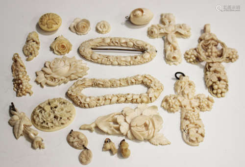 A collection of 19th century carved ivory and bone jewellery, including three pendant crosses, a