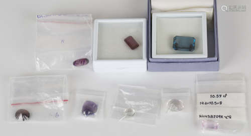 A group of unmounted gemstones, including a rectangular cut cornered step cut blue tourmaline, a