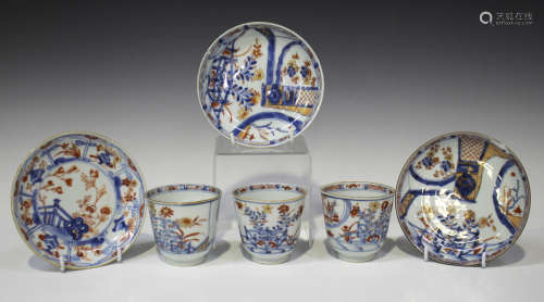A set of three Chinese Imari porcelain cups and two saucers, Kangxi period, each painted and gilt