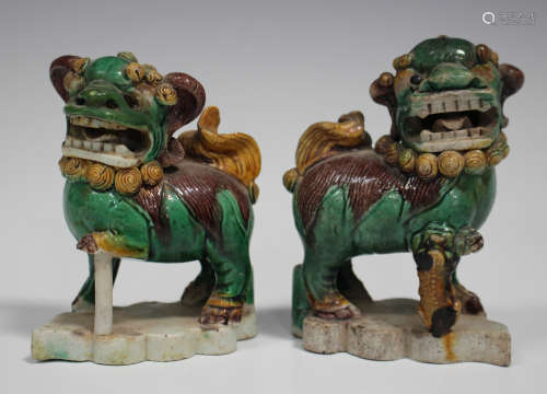 A pair of Chinese famille verte enamelled biscuit porcelain jostick holder figures of Buddhistic