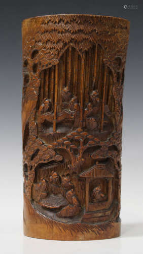 A Chinese carved and pierced bamboo brush pot, early 20th century, decorated with scholars amidst
