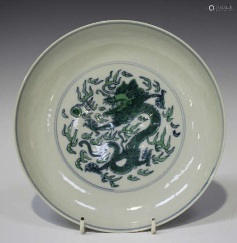 A Chinese doucai green enamelled porcelain saucer dish, mark of Kangxi but later, the centre painted
