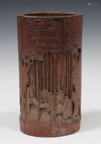 A Chinese bamboo brush pot, early 20th century, carved and pierced with sages in a bamboo grove,