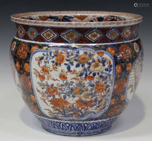 A Japanese Imari porcelain jardinière, Meiji period, the body painted with floral panels reserved